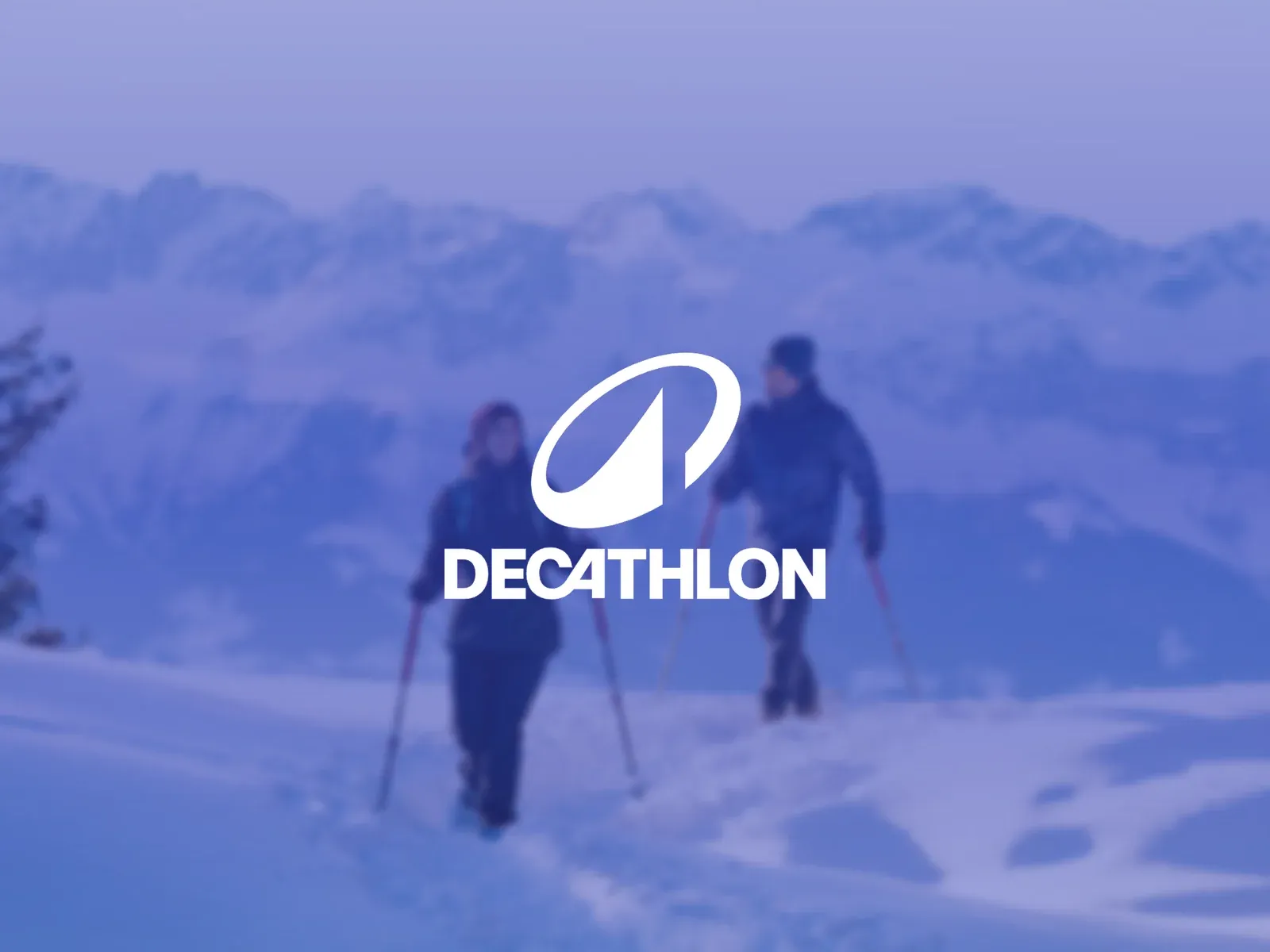 The Decathlon logo over two people snowshoeing in the mountains